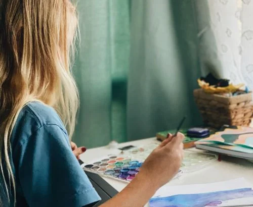 Female student paints a watercolor painting