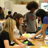 A group of students working on a project in a classroom.