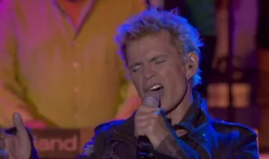 Billy Idol singing into a microphone.